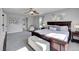 Main bedroom with a king-size bed and ensuite bathroom access at 11960 S Allerton Cir, Parker, CO 80138