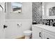 Stylish powder room with black and white patterned tile at 11960 S Allerton Cir, Parker, CO 80138