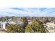 Beautiful city view from an elevated position with trees in the foreground and a blue sky in the background at 2880 S Locust St # 704N, Denver, CO 80222