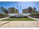 Plaza de Monaco building, 2800 S Locust, with landscaping and flagpoles at 2880 S Locust St # 704N, Denver, CO 80222