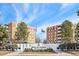 Low angle exterior shot of the Plaza De Monaco community with manicured landscaping and beautiful brick buildings at 2880 S Locust St # 704N, Denver, CO 80222