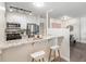 Well-lit kitchen features a breakfast bar, modern stainless steel appliances, and white cabinets at 2880 S Locust St # 704N, Denver, CO 80222