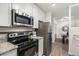 Bright kitchen with stainless steel appliances, white cabinets, and granite countertops at 2880 S Locust St # 704N, Denver, CO 80222