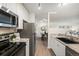 Modern kitchen features stainless steel appliances, granite countertops, and white cabinets at 2880 S Locust St # 704N, Denver, CO 80222