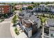 Aerial view of modern townhouses with rooftop decks in a vibrant community, with Denver skyline in the background at 2804 W 53Rd Ave, Denver, CO 80221