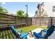 Cozy backyard featuring artificial turf, modern privacy fencing, and comfortable seating for outdoor relaxation at 2804 W 53Rd Ave, Denver, CO 80221