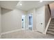 Neutral-toned basement with access to bathroom, stairs, and doorway to another room, all carpeted at 2804 W 53Rd Ave, Denver, CO 80221
