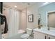 Bathroom featuring a shower and tub combination, single sink vanity, framed mirror at 2804 W 53Rd Ave, Denver, CO 80221