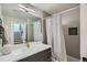 Stylish bathroom with a combination shower and tub, modern gray tiling, and a quartz vanity at 2804 W 53Rd Ave, Denver, CO 80221