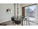 Modern dining area featuring glass table and designer chairs near outdoor light at 2804 W 53Rd Ave, Denver, CO 80221