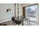 Bright dining area with glass table and chairs, leading to a patio at 2804 W 53Rd Ave, Denver, CO 80221