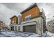 Two modern townhomes with wood siding and attached garages at 2804 W 53Rd Ave, Denver, CO 80221