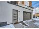Attached garage and modern front door with entryway at 2804 W 53Rd Ave, Denver, CO 80221