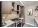 Modern kitchen with stainless steel appliances and gray tile backsplash at 2804 W 53Rd Ave, Denver, CO 80221