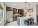 Contemporary kitchen with stainless steel appliances, gray cabinets, quartz countertops, and barstool seating at 2804 W 53Rd Ave, Denver, CO 80221