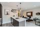 Modern kitchen with island, stainless steel appliances, and open concept to living room at 2804 W 53Rd Ave, Denver, CO 80221