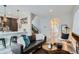 Open-concept living room with modern decor, hardwood floors, and a seamless flow to the kitchen area at 2804 W 53Rd Ave, Denver, CO 80221