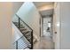 Modern upper hallway with sleek metal railing staircase and carpet flooring at 2804 W 53Rd Ave, Denver, CO 80221