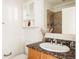 Bathroom with a granite-style countertop, white cabinets, and shower at 2680 Blake St # 12, Denver, CO 80205