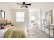 Light and airy bedroom with a ceiling fan, soft carpet, and artful décor at 2680 Blake St # 12, Denver, CO 80205