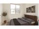 Neutral bedroom features art, a large window and potted plant at 2680 Blake St # 12, Denver, CO 80205