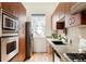 Modern kitchen features built-in stainless steel appliances, sink and wood cabinets at 2680 Blake St # 12, Denver, CO 80205