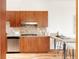 Modern kitchen features sleek appliances, stone countertops, and functional island seating at 2680 Blake St # 12, Denver, CO 80205