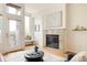 Cozy living room enhanced by a fireplace and natural light streaming through ample windows at 2680 Blake St # 12, Denver, CO 80205