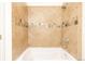 Shower with mixed tile, decorative trim, and tub at 2680 Blake St # 12, Denver, CO 80205