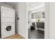 A modern bathroom featuring a sleek vanity, contemporary fixtures, and in-unit washer and dryer at 891 14Th St # 2914, Denver, CO 80202