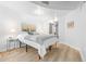 Cozy bedroom offers a large bed, soft lighting, and modern decor with a white and grey color palette at 891 14Th St # 2914, Denver, CO 80202