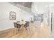 Bright living room with wood floors, city views, and dining area featuring modern chandelier lighting at 891 14Th St # 2914, Denver, CO 80202