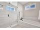 Serene bathroom featuring a glass-enclosed shower, a soaking tub, and modern fixtures at 11269 Star Streak Rd, Littleton, CO 80125