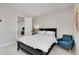 This is a primary bedroom with a queen-size bed and a blue armchair at 11269 Star Streak Rd, Littleton, CO 80125