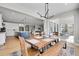 Open floor plan with dining room table next to sliding glass doors, kitchen with island and a view of living room at 11269 Star Streak Rd, Littleton, CO 80125