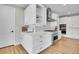 Bright kitchen with white cabinetry, stainless steel appliances, and wood floors at 11269 Star Streak Rd, Littleton, CO 80125