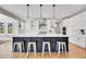 Spacious kitchen with a large island, pendant lighting, and modern appliances at 11269 Star Streak Rd, Littleton, CO 80125