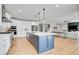 Spacious kitchen with a large island, stainless steel appliances, and open floor plan at 11269 Star Streak Rd, Littleton, CO 80125