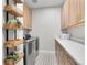 Well-organized laundry room with modern appliances, storage cabinets, and stylish decor at 11269 Star Streak Rd, Littleton, CO 80125