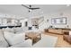 Bright living room showcasing a modern sectional sofa and an open layout to the kitchen at 11269 Star Streak Rd, Littleton, CO 80125