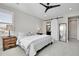Stylish main bedroom features neutral tones, ensuite bathroom with sliding barn door, and modern ceiling fan at 11269 Star Streak Rd, Littleton, CO 80125