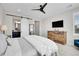Comfortable main bedroom boasts ceiling fan, ensuite bathroom with sliding barn door, and a large dresser at 11269 Star Streak Rd, Littleton, CO 80125