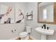 Chic powder room with modern fixtures, floating shelves, and stylish artwork at 11269 Star Streak Rd, Littleton, CO 80125