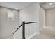 Staircase with white railings and black trim with a view of a window and the upstairs at 11269 Star Streak Rd, Littleton, CO 80125