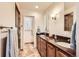 Bathroom featuring double sinks, granite counters, and a walk-in shower at 1470 S Quebec Way # 46, Denver, CO 80231