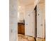 Hallway leads to a bathroom that features granite counters, a sink and a mirrored closet at 1470 S Quebec Way # 46, Denver, CO 80231
