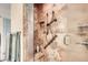 Walk-in shower features beautiful tile surround, safety bars, and glass door at 1470 S Quebec Way # 46, Denver, CO 80231