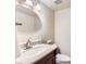 Cozy bathroom with sleek countertop and large round mirror at 1470 S Quebec Way # 46, Denver, CO 80231