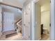 Welcoming entryway with tiled floors and a view of the staircase and half bathroom at 1470 S Quebec Way # 46, Denver, CO 80231