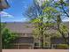 Charming townhouse exterior framed by mature trees and a sunny sky at 1470 S Quebec Way # 46, Denver, CO 80231